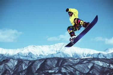 Snowboarding while enjoying views of the mountains